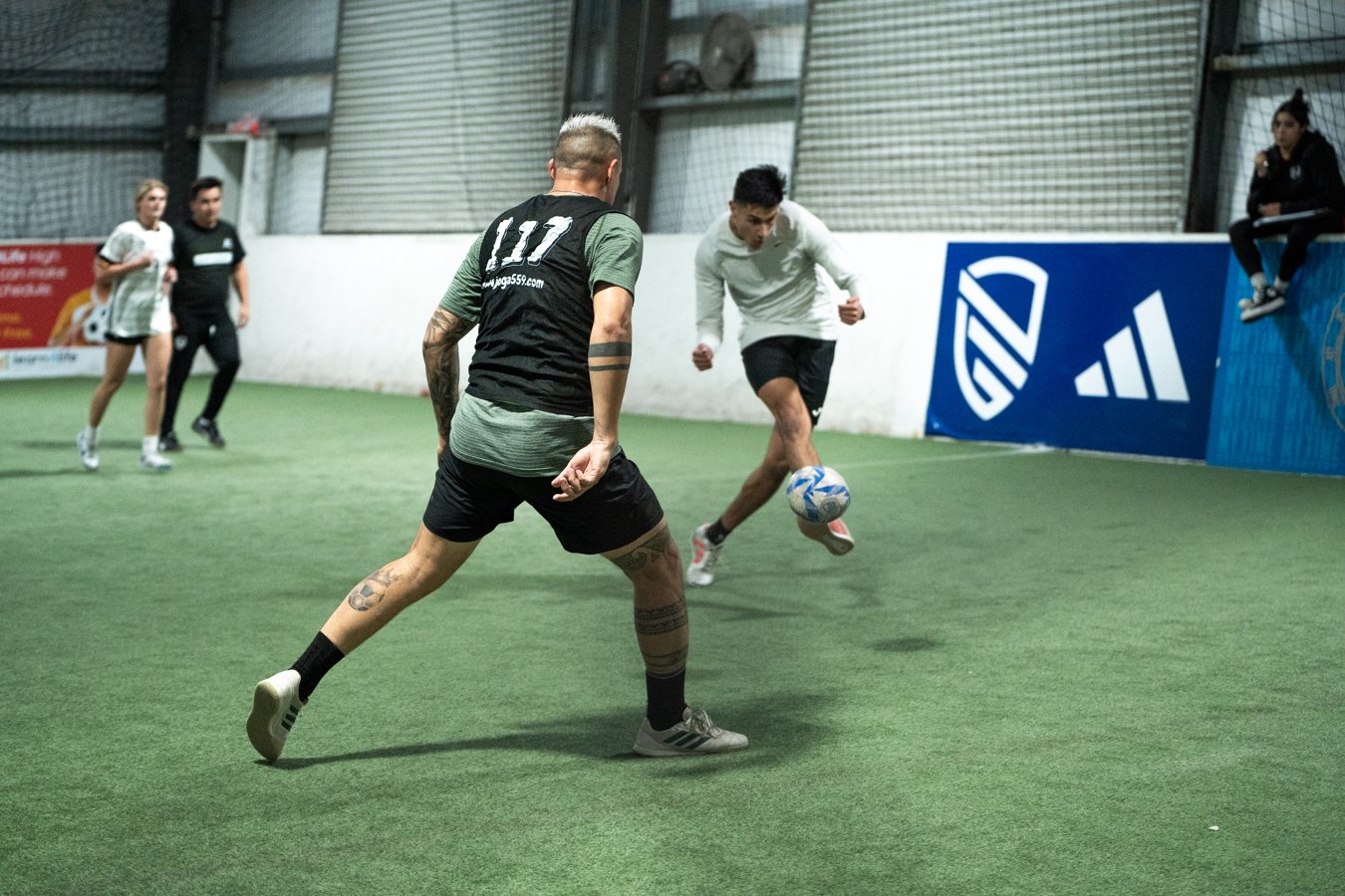 2 men kicking a soccer ball